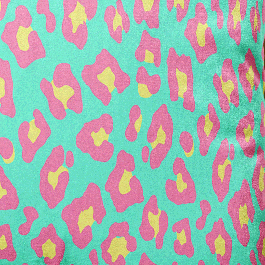 leopard print cushion in pink and green with gold piping