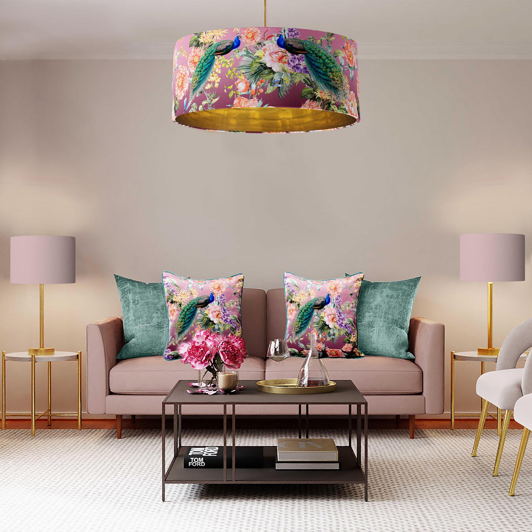 Peacock paradise in pink velvet lampshade with gold lining pictured in living room above sofa with matching velvet cushions