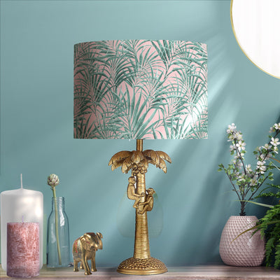 Palms Delight Lampshade with Mirror Gold Lining, pictured on gold tropical lamp base in living room setting