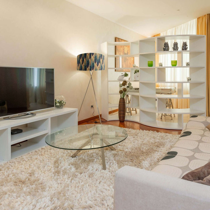 Autumn Leaves velvet lampshade pictured in white living room next to tv stand and double sided bookshelf